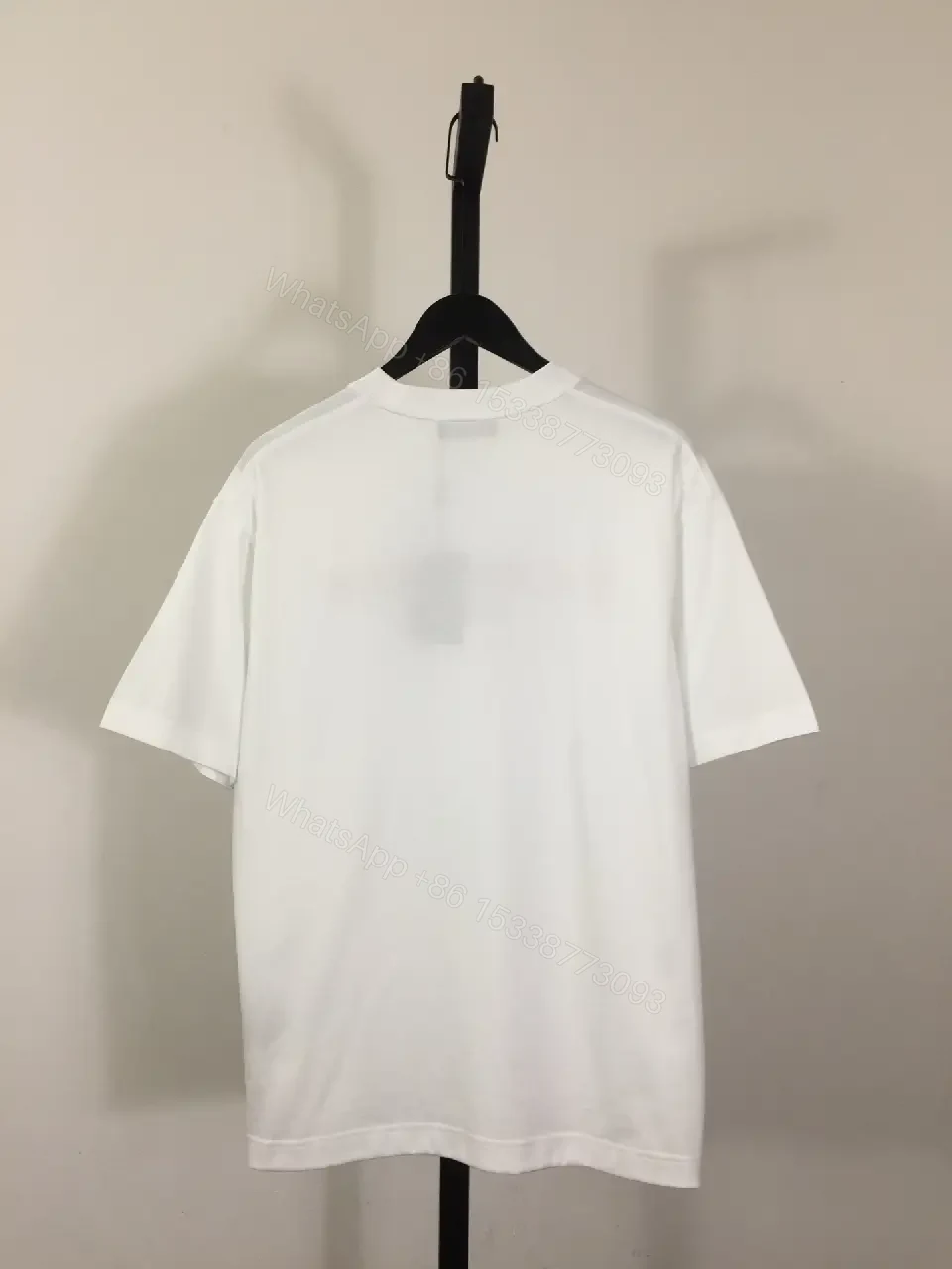 View 6 of Minimalist White Logo Tee with Bold Red Crest