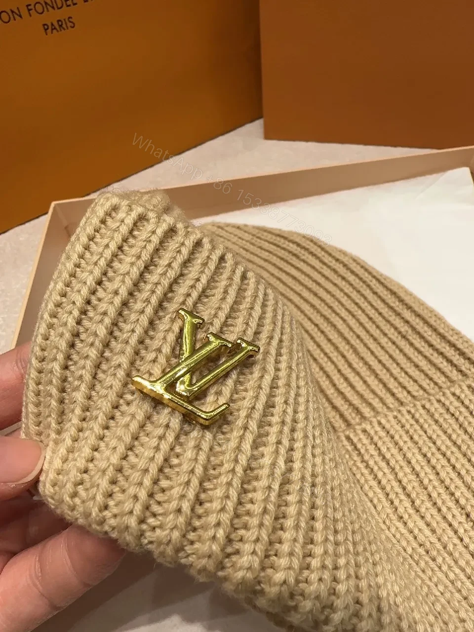 View 3 of Textured Camel Knit Beanie with Gold Crest - Cozy Luxury Style