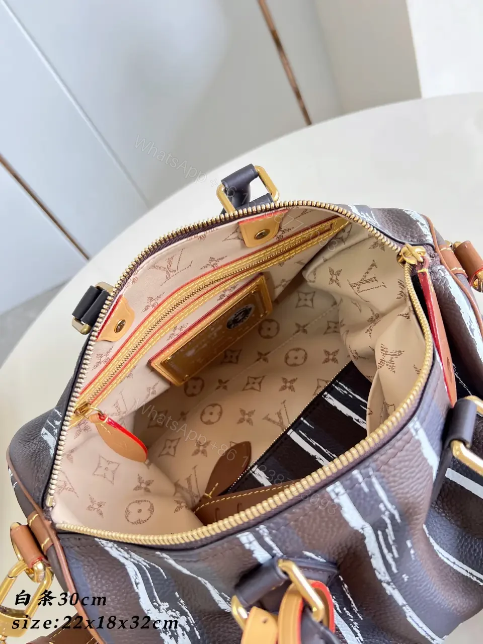 View 2 of Brown leather handbag with striped monogram pattern for luxury everyday use