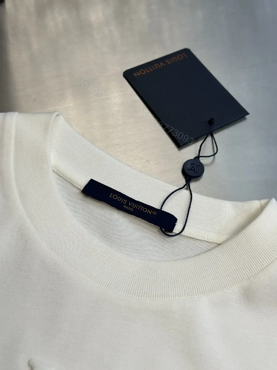 View 6 of Oversized White Tee with Subtle Embossed Logo - Minimal Luxury