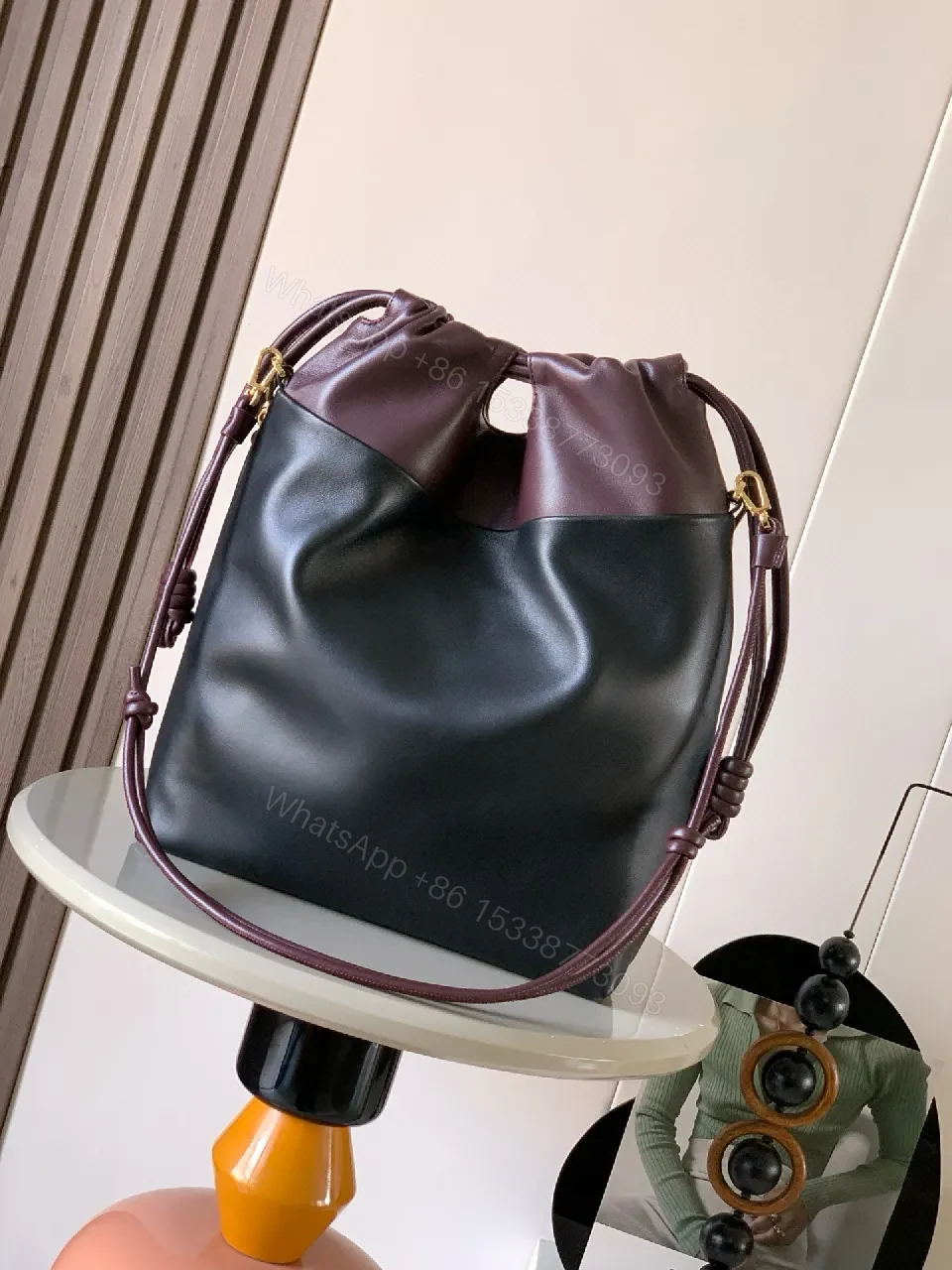 View 7 of Two-Tone Leather Drawstring Bucket Bag with Chain Detail