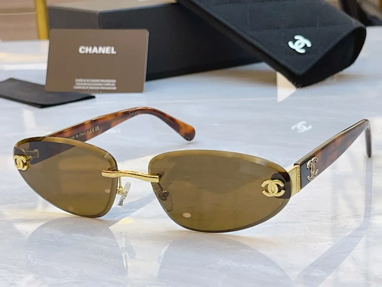 View 7 of Luxurious Silver-Gray Sunglasses: Gold Accents, Semi-Rimless Oval, Chanel Hardware
