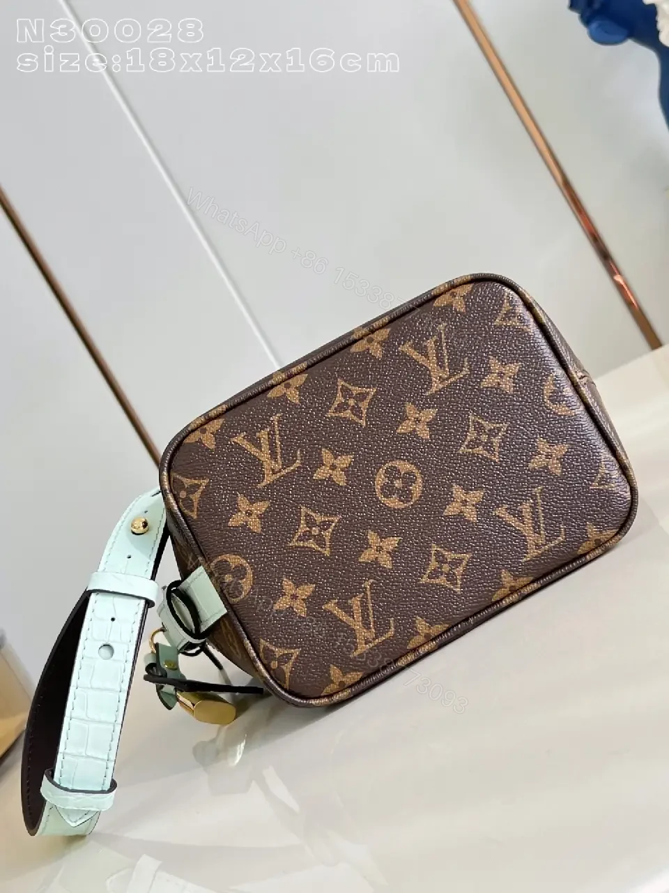 View 6 of Brown Monogram Bucket Bag: Structured Crossbody with Aqua Strap