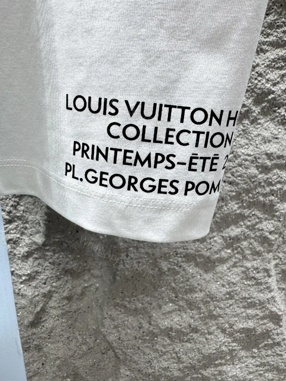 View 7 of Minimalist White T-Shirt with Subtle LV.M Emblem - Premium Cotton