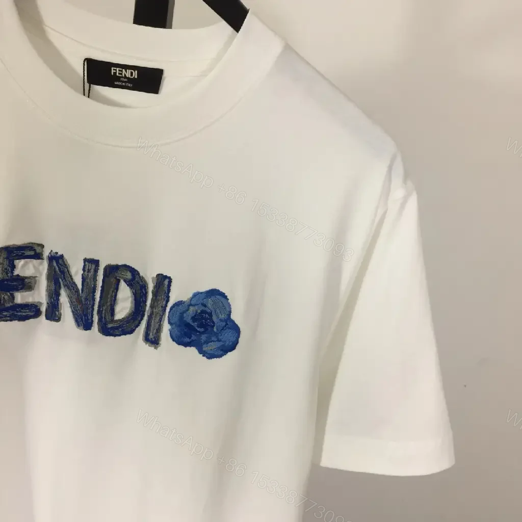 View 8 of White Cotton/Poly blend Short-sleeve Crew Neck Bold FENDI logo with blue flower T-shirt