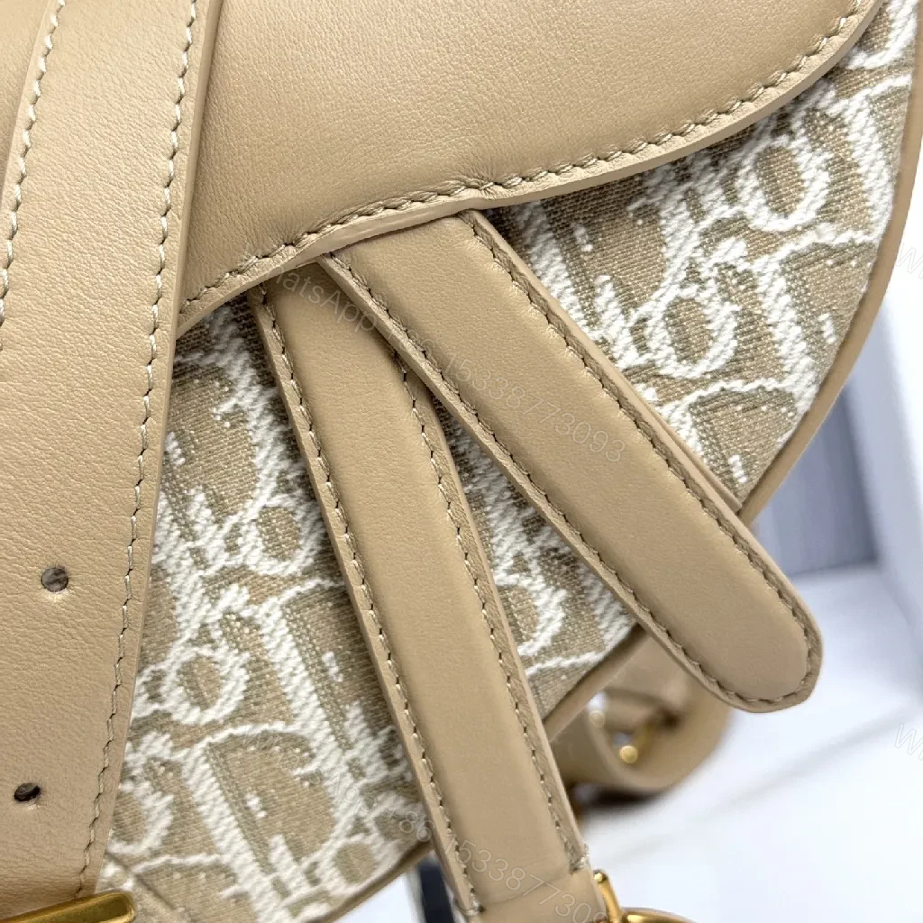 View 8 of Beige Leather-Trim Mini Saddle Bag, Monogram Canvas, Crossbody