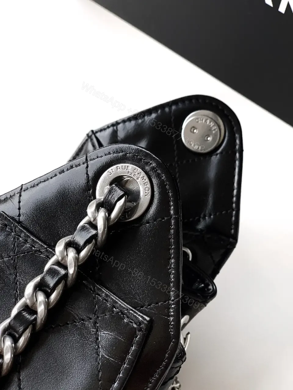 View 8 of Quilted Black Leather Bag with Chain Strap—Compact Elegance