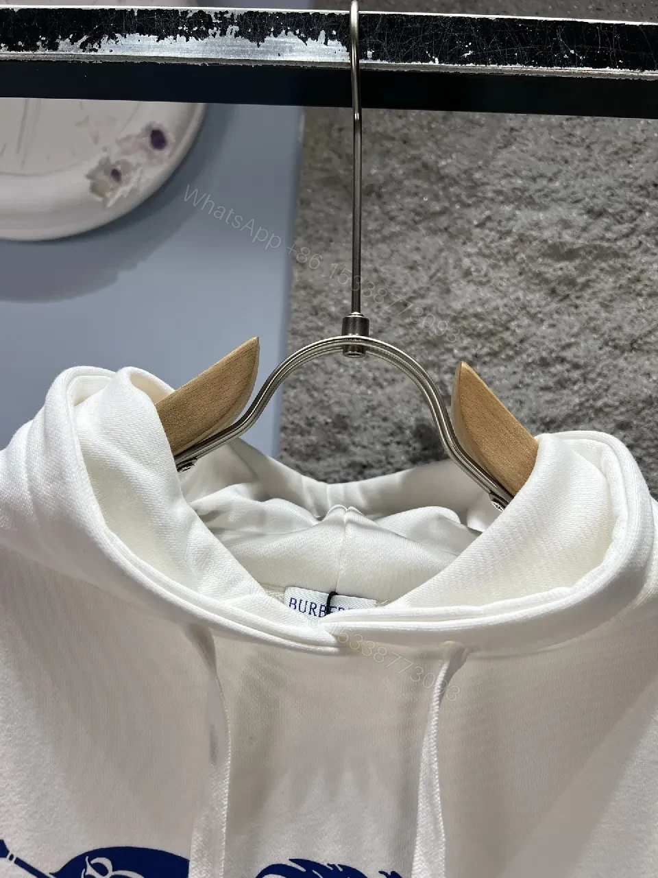 View 5 of White Hoodie with Bold Crest Graphic—Premium Comfort Streetwear