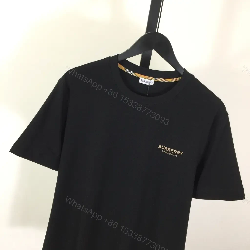 View 3 of Minimalist Black Cotton Tee, Subtle Logo, Everyday Comfort