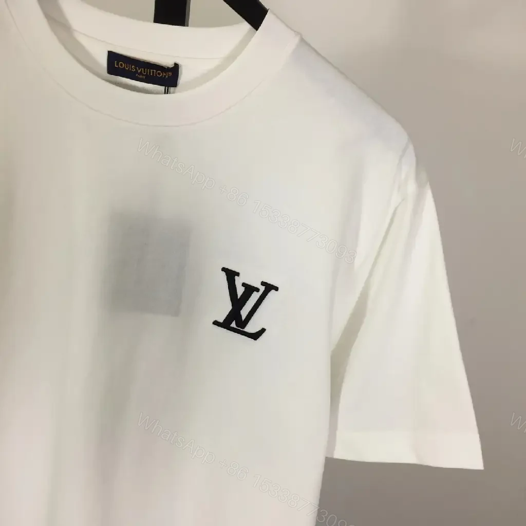 View 8 of Classic White Tee - Premium Cotton, Subtle Emblem, Everyday Luxe