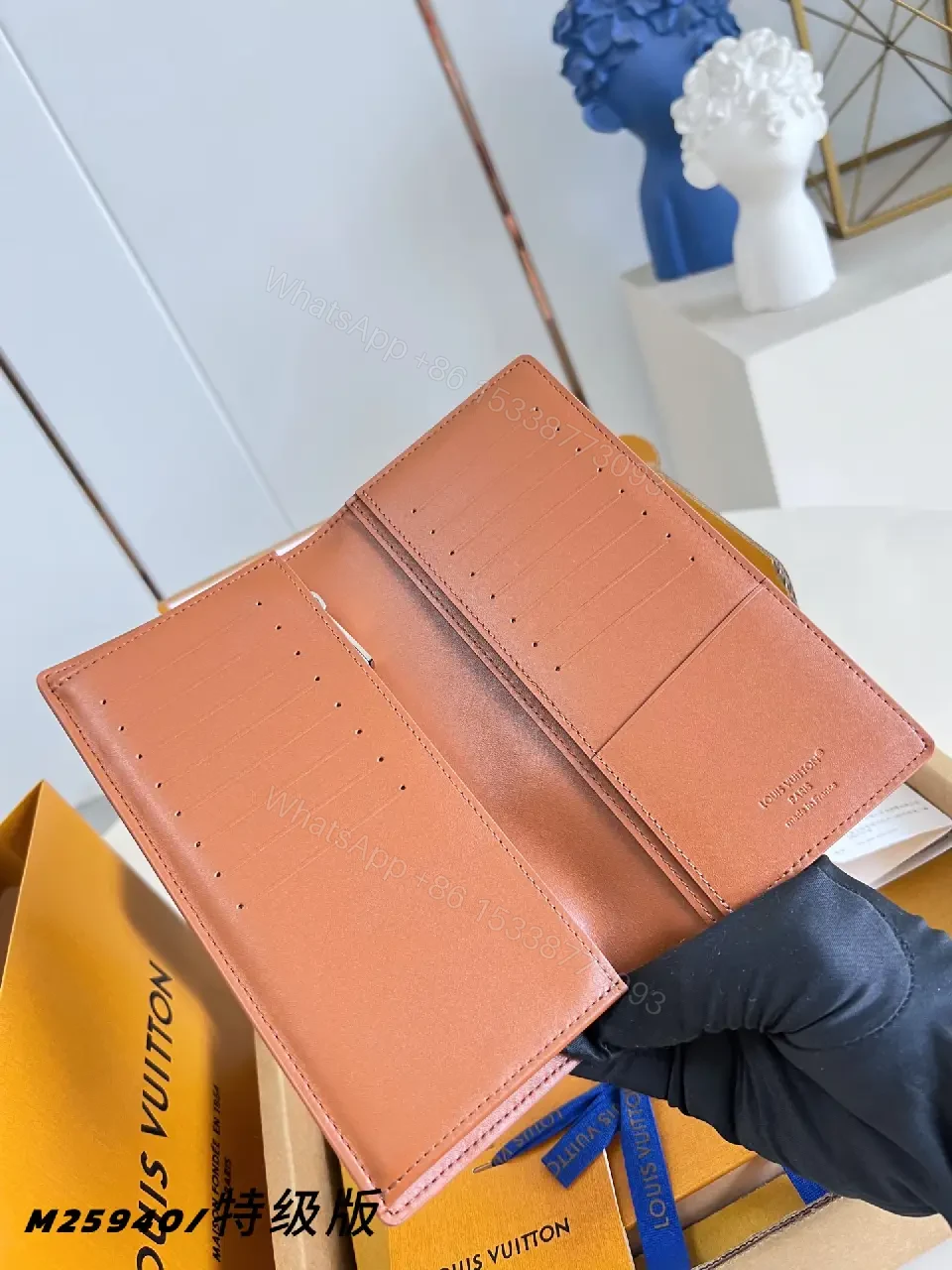 View 8 of Light Brown/Pale Pink Pebbled Leather Bi-Fold Wallet with LV Embossed Logo