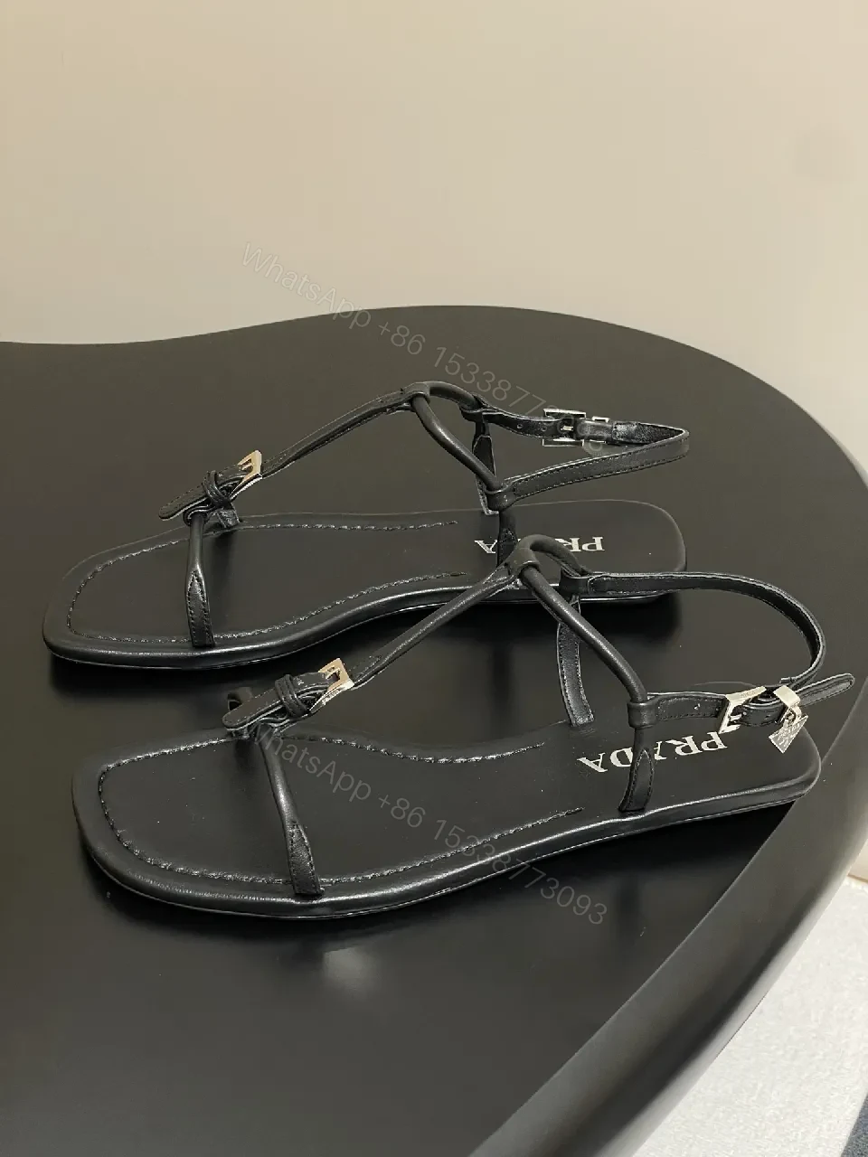 View 9 of Minimal Black Leather T-Strap Sandals with Padded Comfort