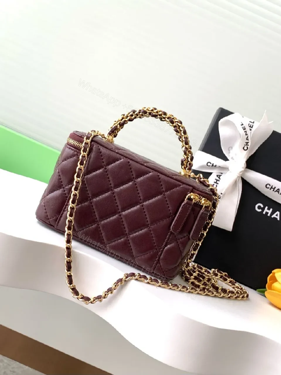 View 2 of Quilted Burgundy Bag with Gold Chain Handle—Compact Luxury