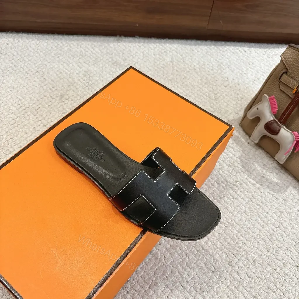 View 9 of black leather slide sandals with H-shaped buckles for luxury everyday