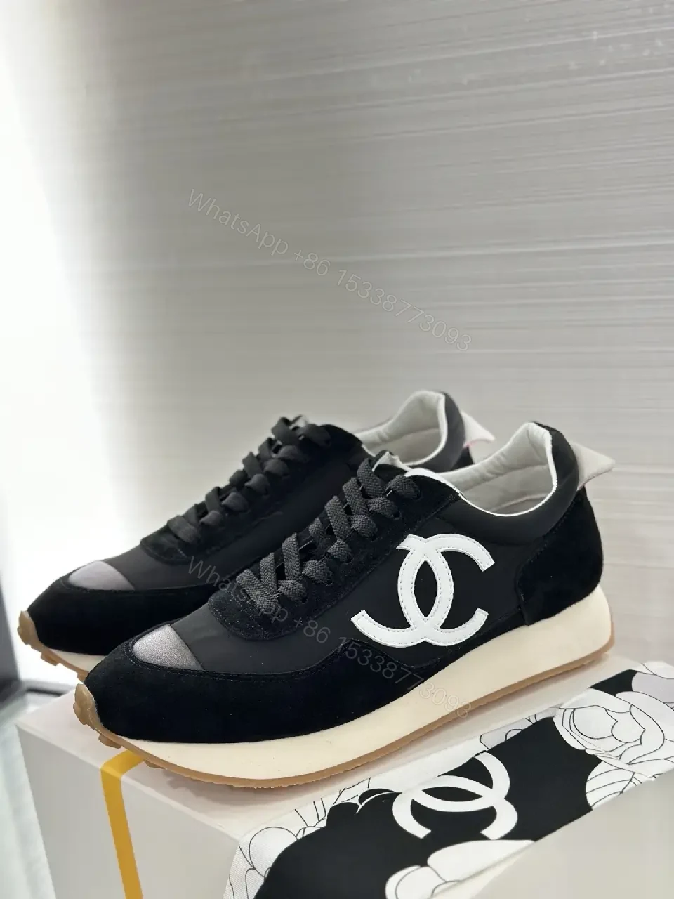 View 3 of Sleek Black Knit High-Top Sneaker with Signature Emblem, Luxury