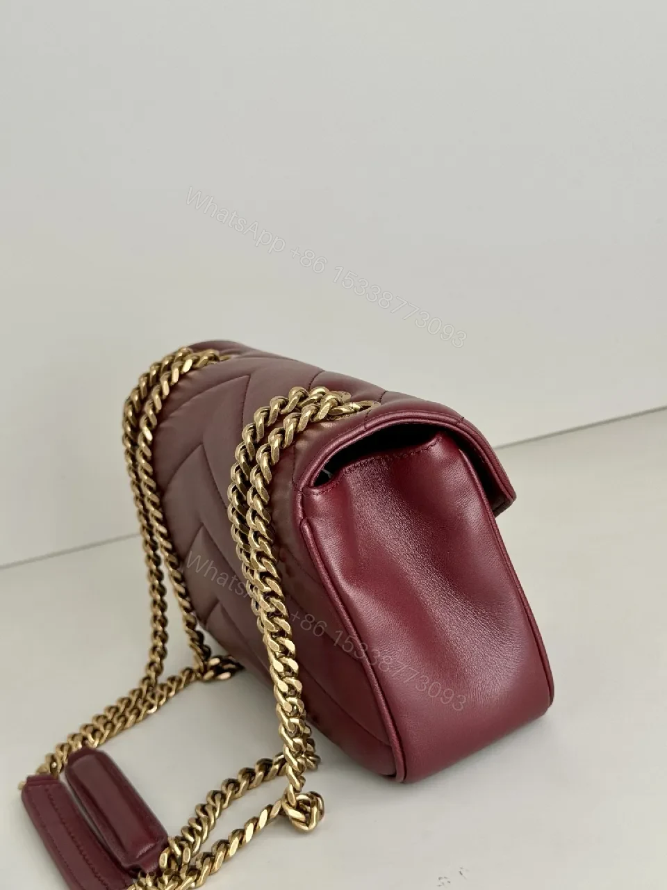 View 2 of Burgundy Quilted Satchel with Gold Chain Detail