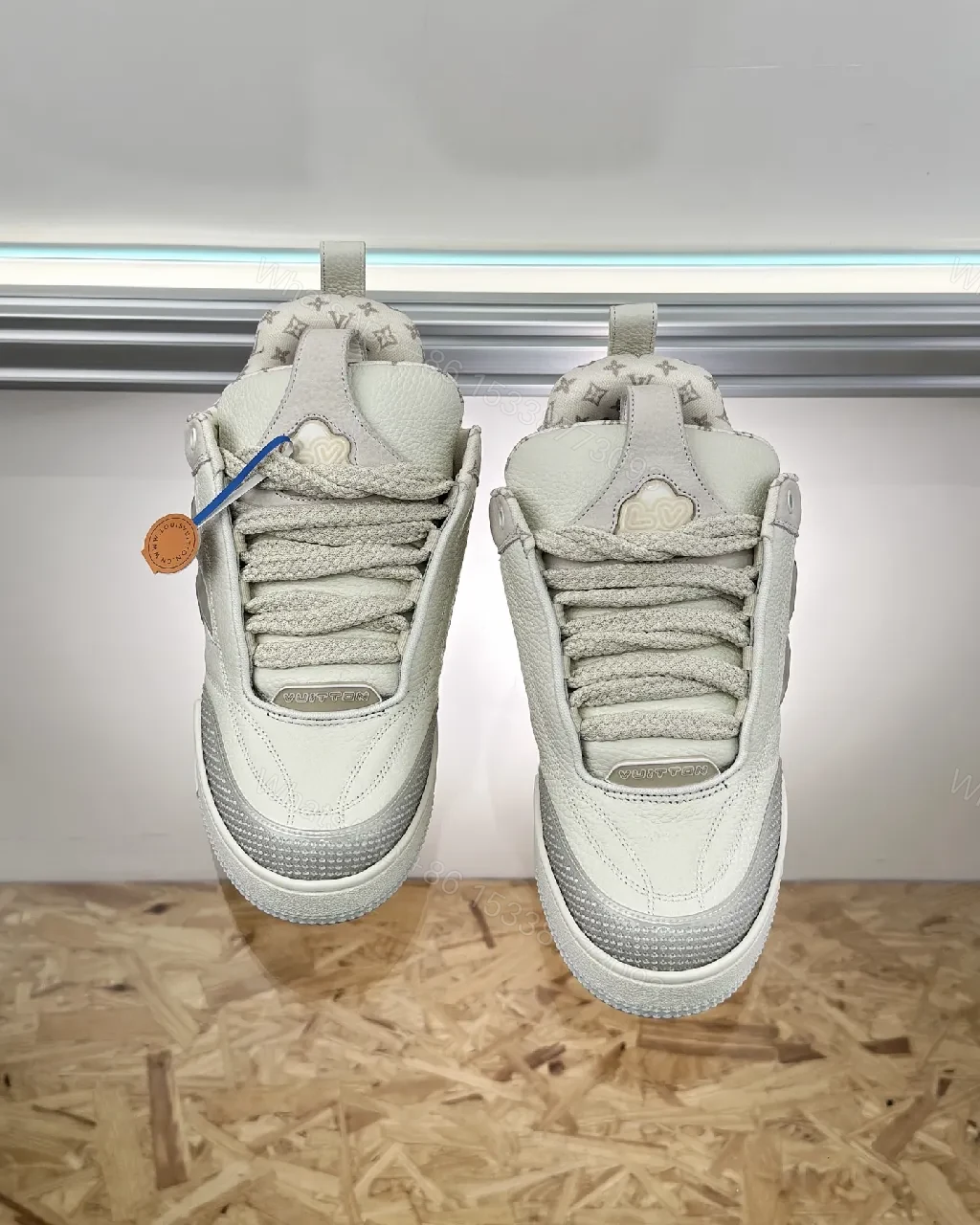 View 4 of Textured White Leather Sneakers with Signature Motif, Modern Luxury