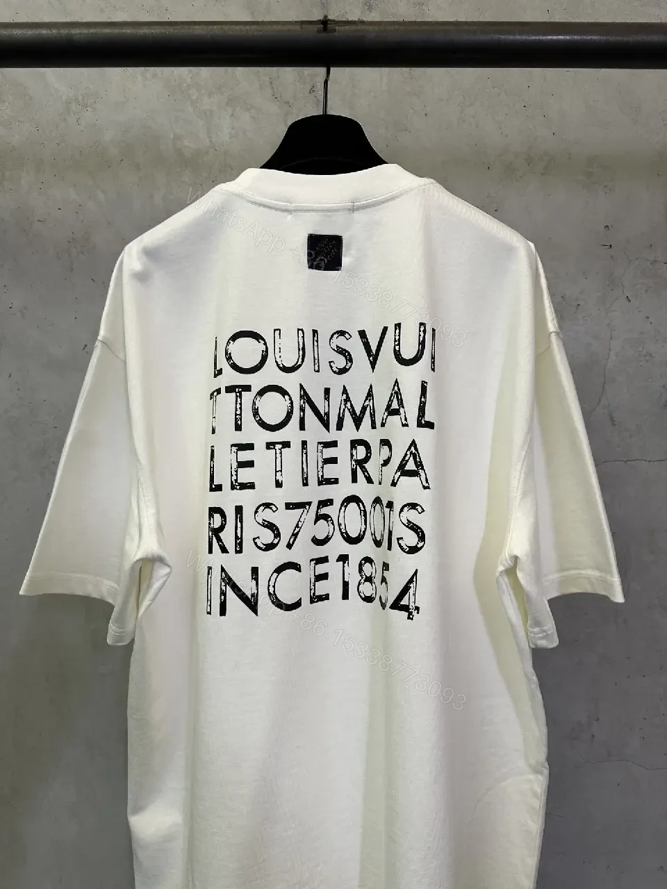 View 2 of Minimalist White Tee with Subtle LV.M. Marking — Premium Everyday Wear
