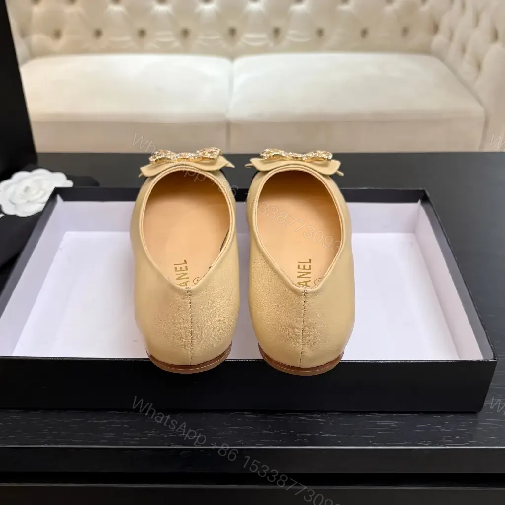 View 2 of Beige Leather Flats with Black-Toe Cap & Crystal Bow