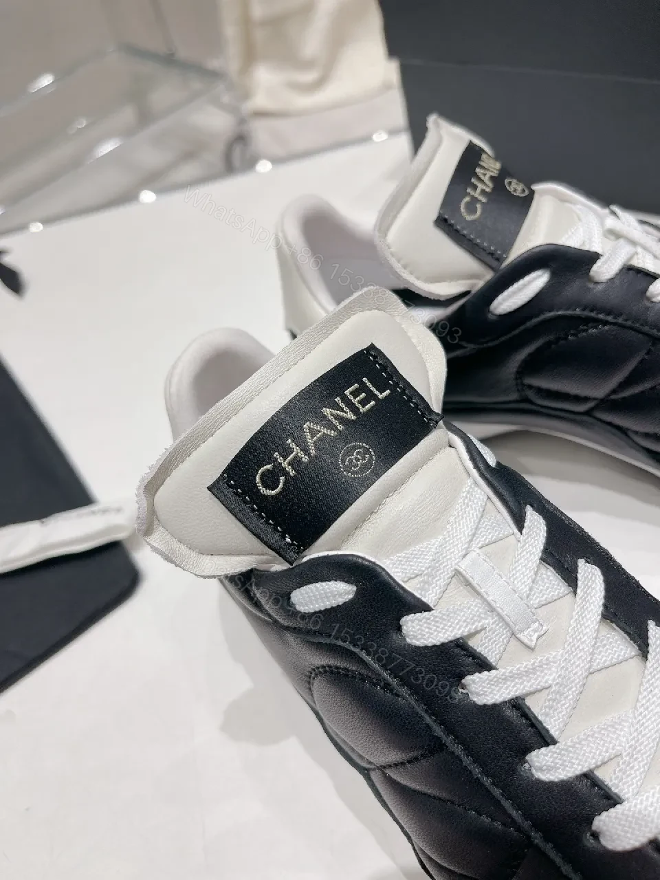 View 3 of Quilted Black Leather Sneakers with Luxe Branding Detail