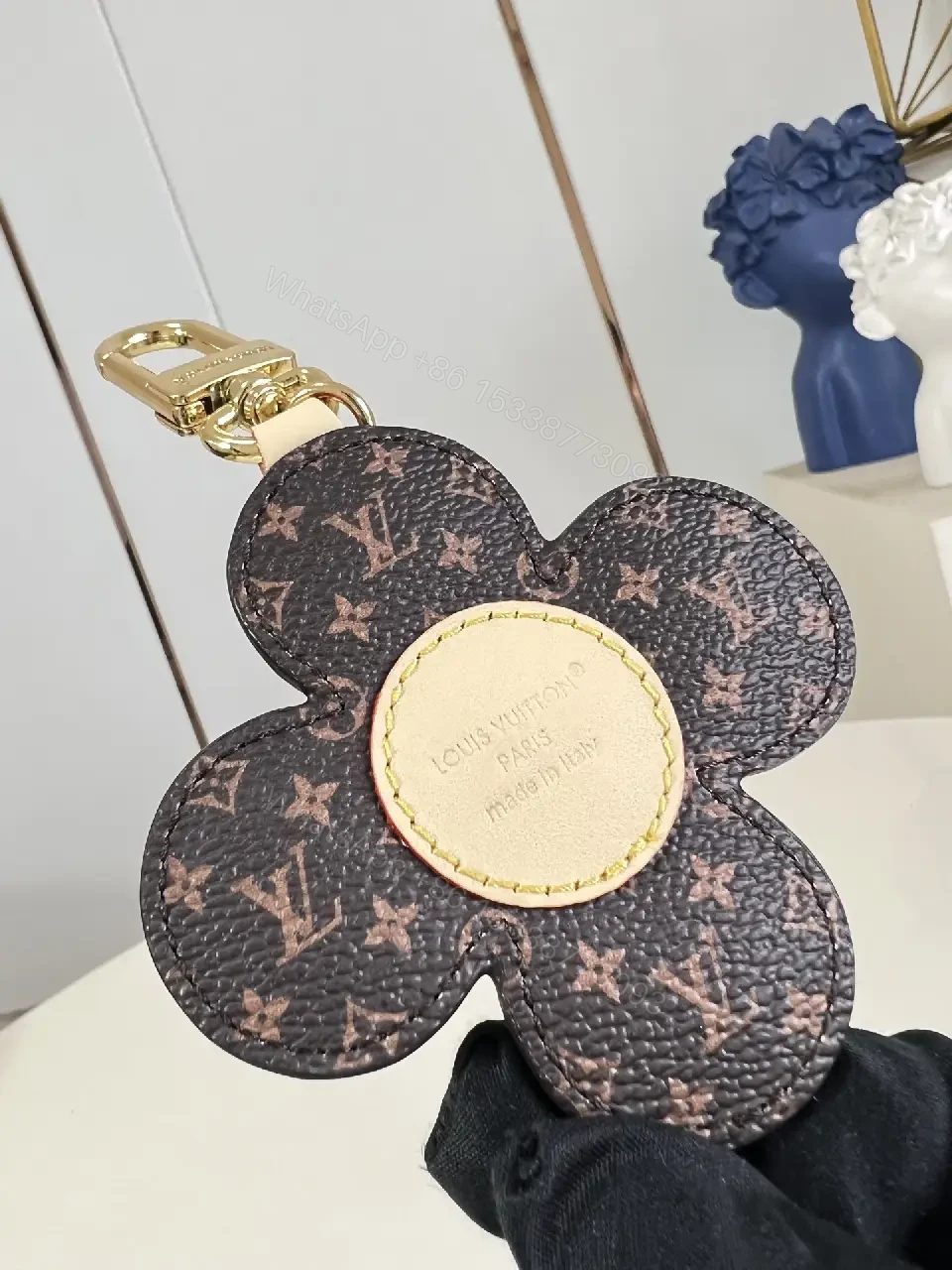 View 5 of White Leather-like Quilted Flower Keychain - LV Monogram Accent, Gold Hardware
