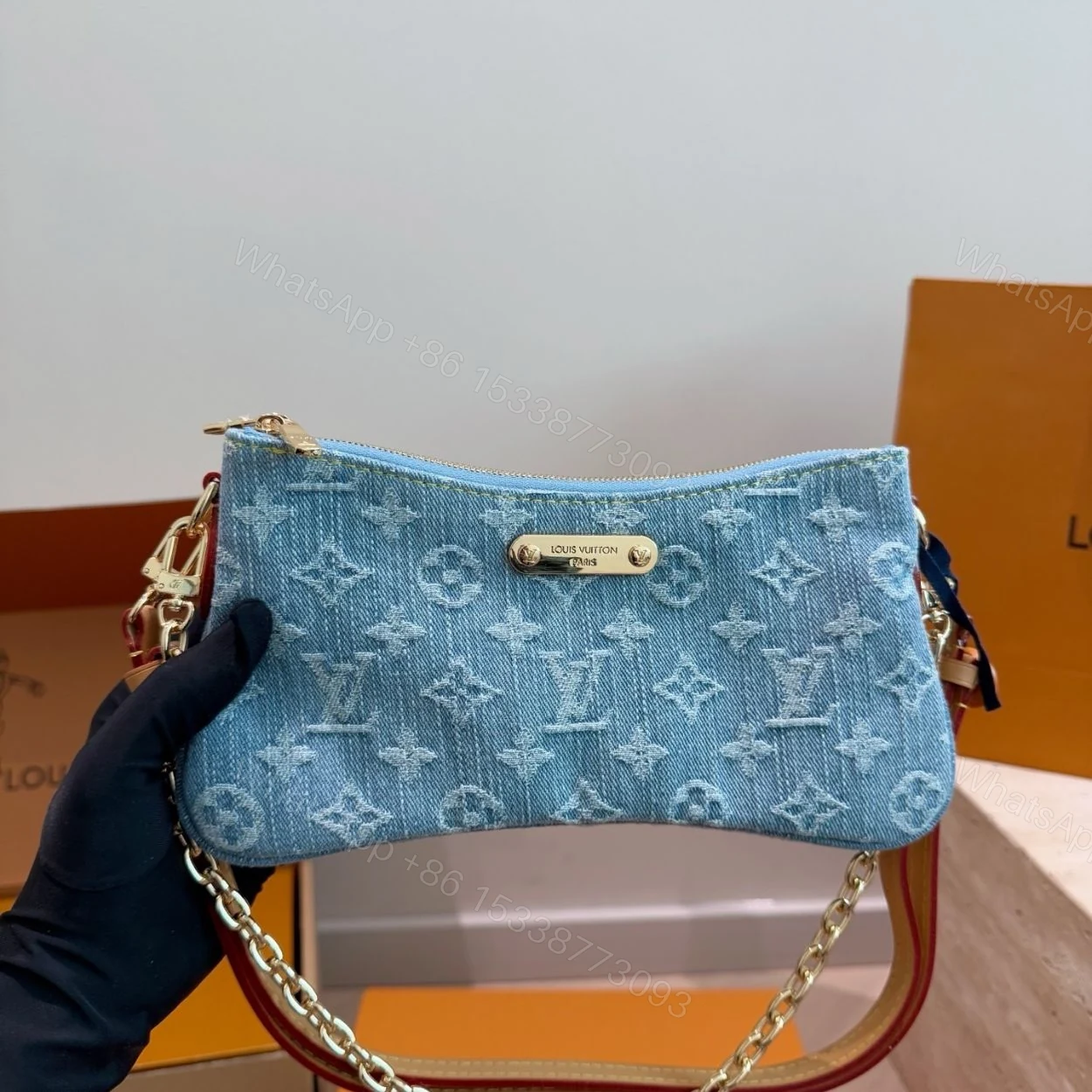 View 2 of Louis Vuitton Liv Pochette Blue Denim 25Cm M83532