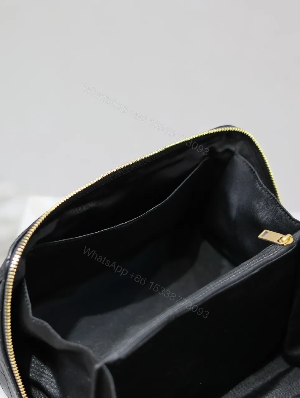 View 2 of Compact Black Quilted Leather Vanity Bag with Gold Monogram