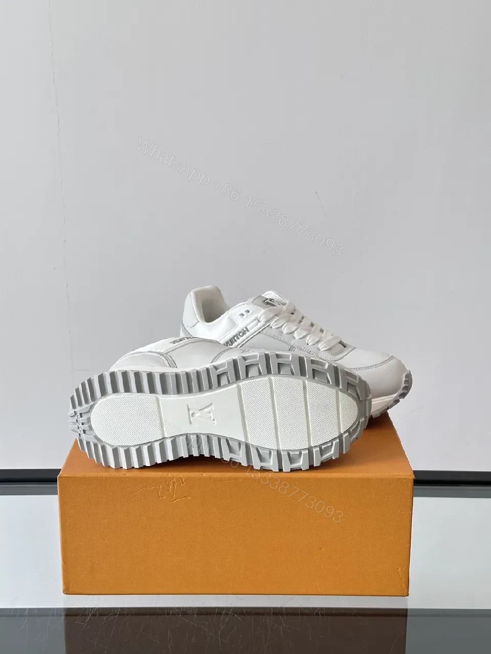 View 2 of Minimalistic White Leather Sneakers with Subtle Texture and Monogram Accent
