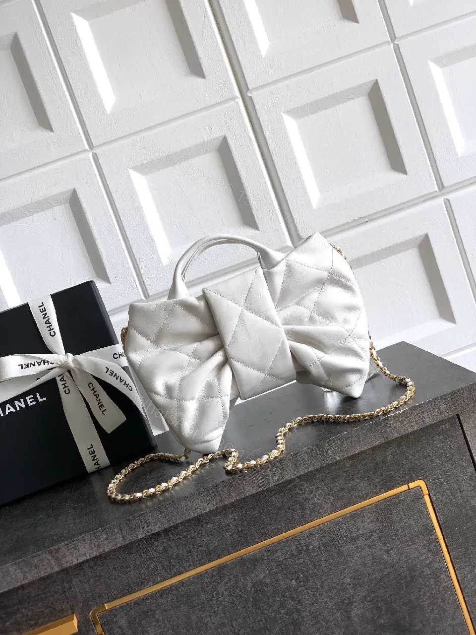 View 5 of Pearl White Quilted Satin Mini Bag with Bow Detail and Gold Logo