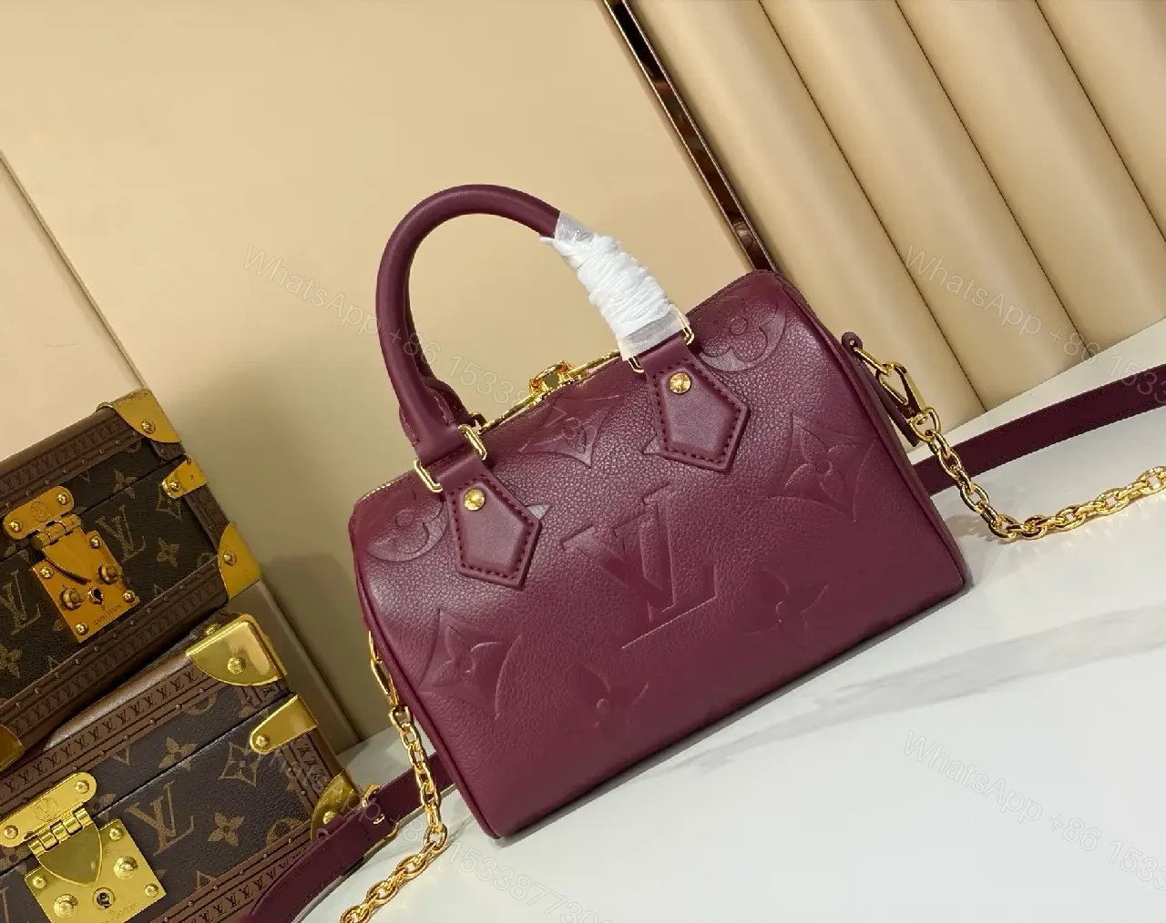 View 8 of Deep Plum Leather Satchel: Structured Top-Handle Bag with Embossed LV Motifs