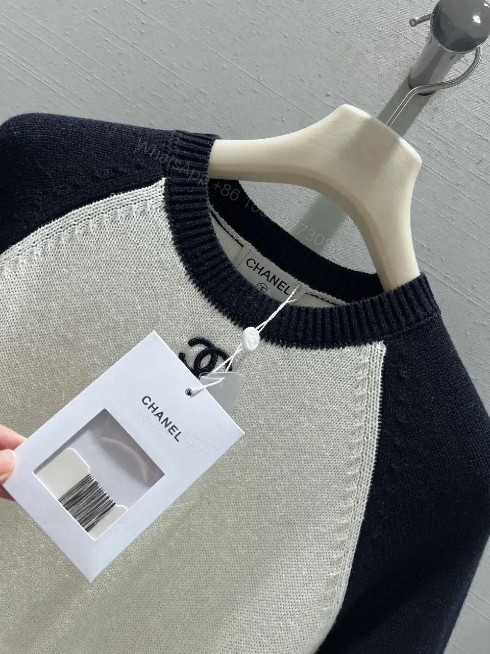 View 10 of Two-Tone Knit Tee with Signature Logo Emblem - Modern Luxury Casual