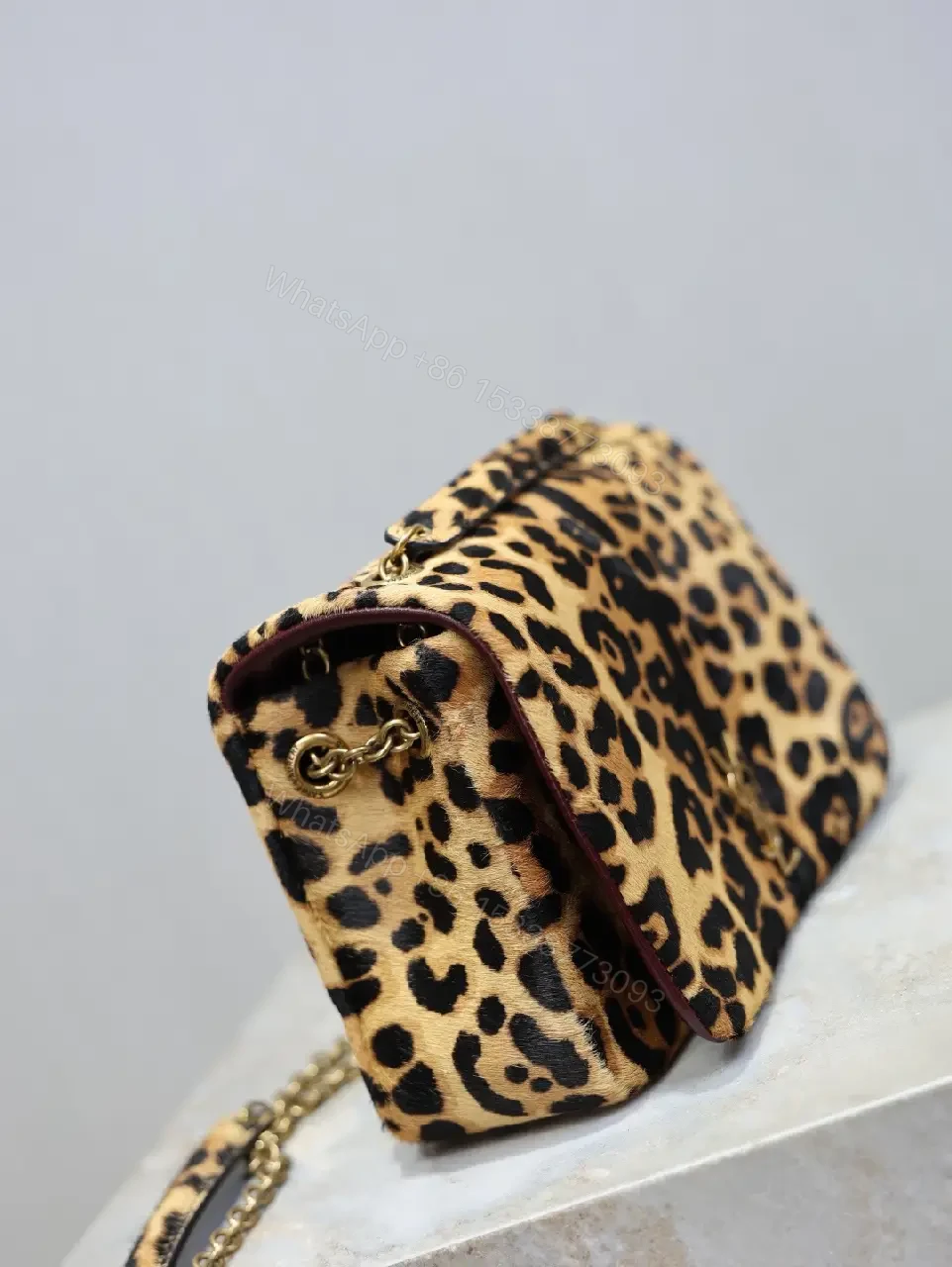View 4 of Leopard Print Mini Bag with Gold Accent: Compact Luxury Bag