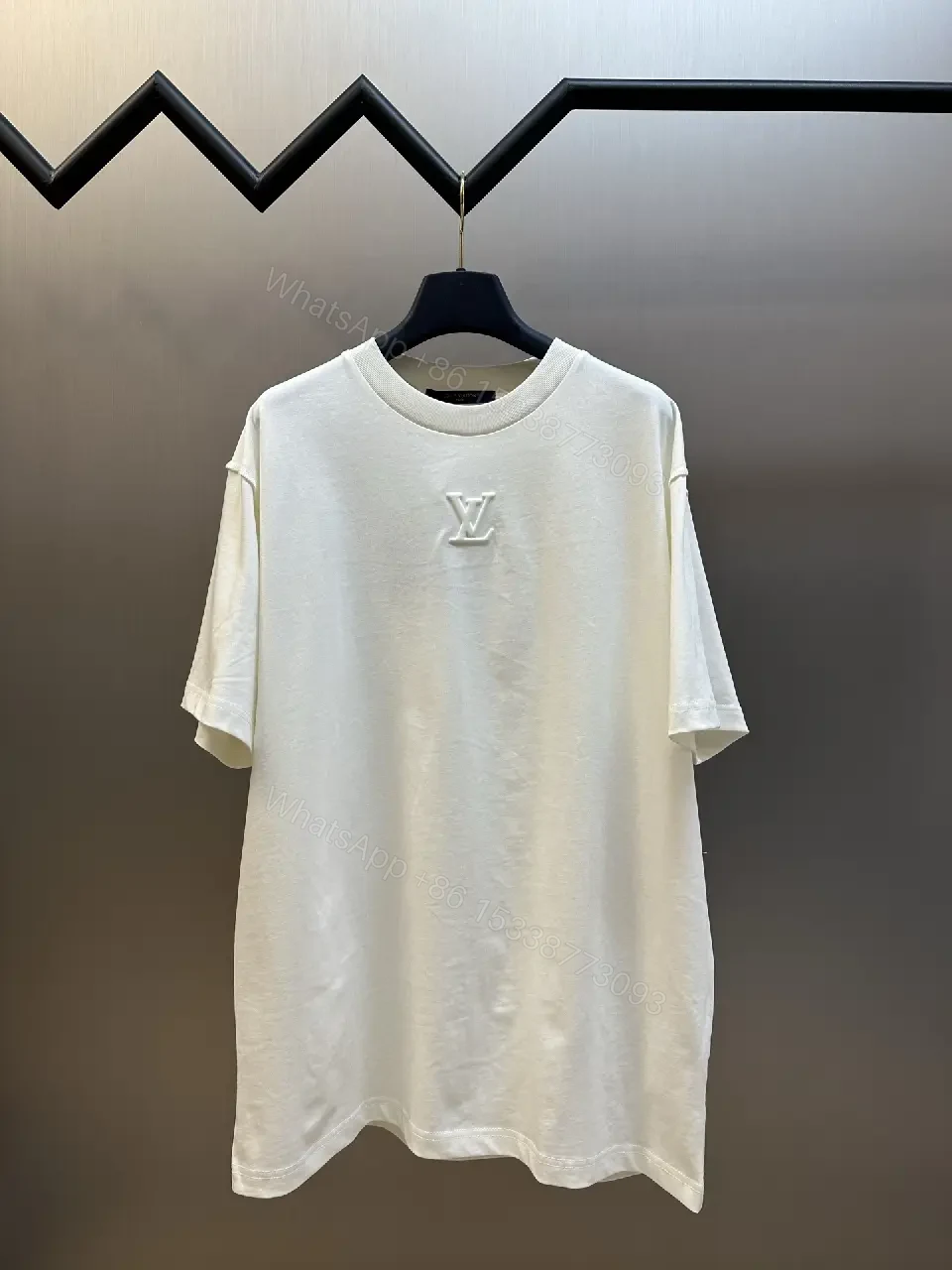 View 3 of Oversized White Tee with Subtle Embossed Logo - Minimal Luxury