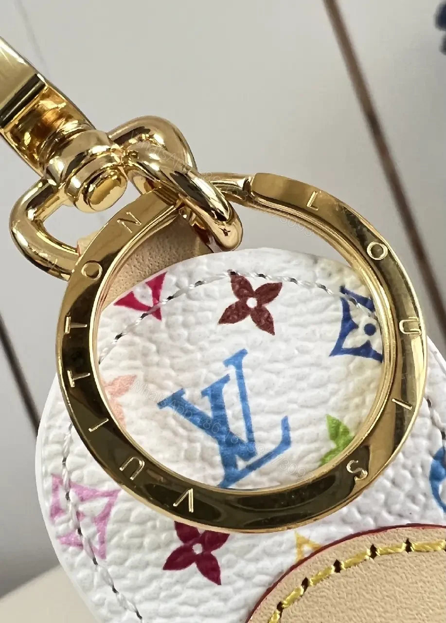 View 3 of White Leather-like Quilted Flower Keychain - LV Monogram Accent, Gold Hardware