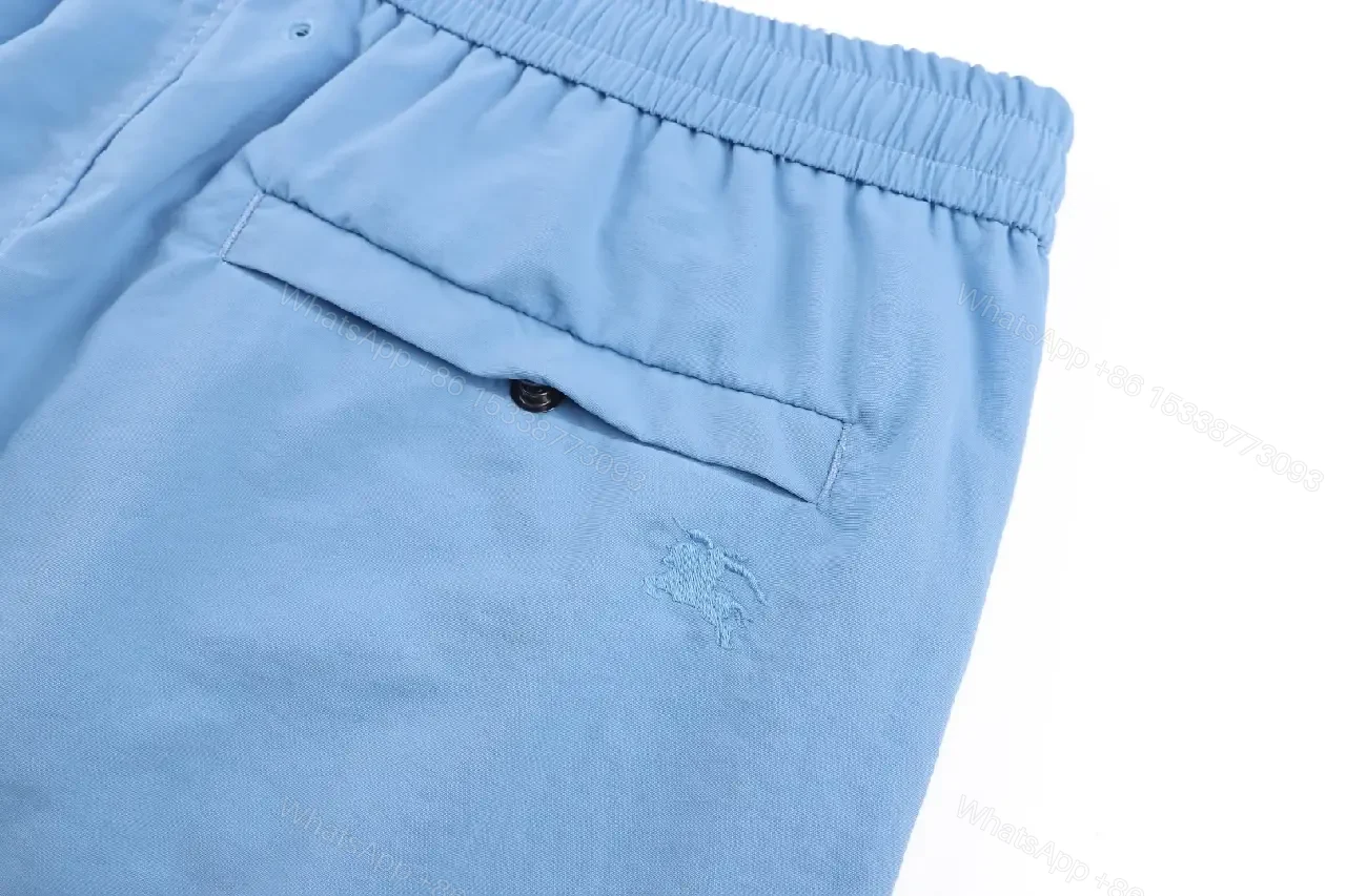 View 7 of Light Blue Cotton-Blend Swim Shorts with Burberry-Check Side Strips