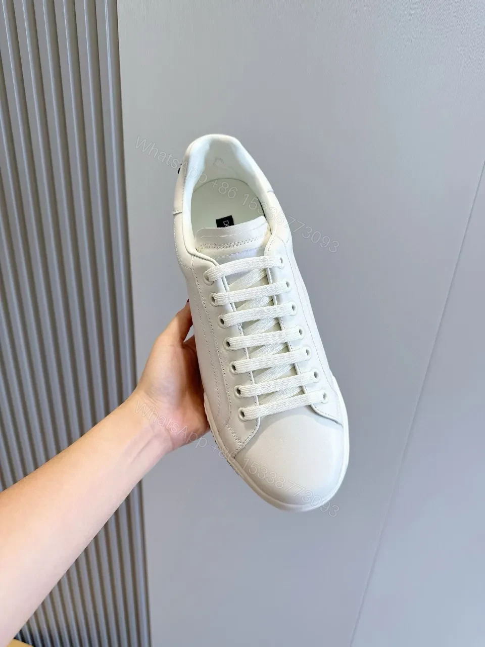 View 5 of Minimal White Leather Sneakers with Subtle Designer Detailing