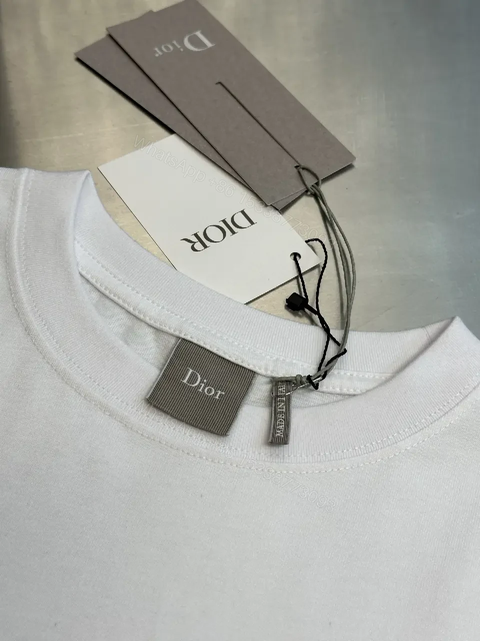 View 9 of Minimalist White Logo Tee - Premium Cotton, Modern Fit, Graphic Accent