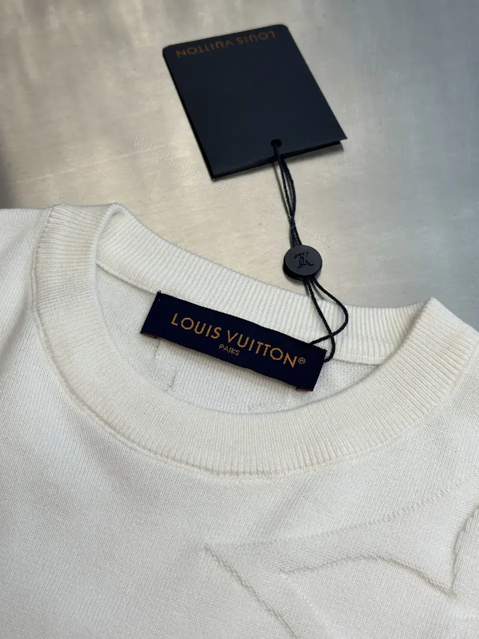 View 2 of Off-White Cream Oversized Tee with Embossed Logo Pattern
