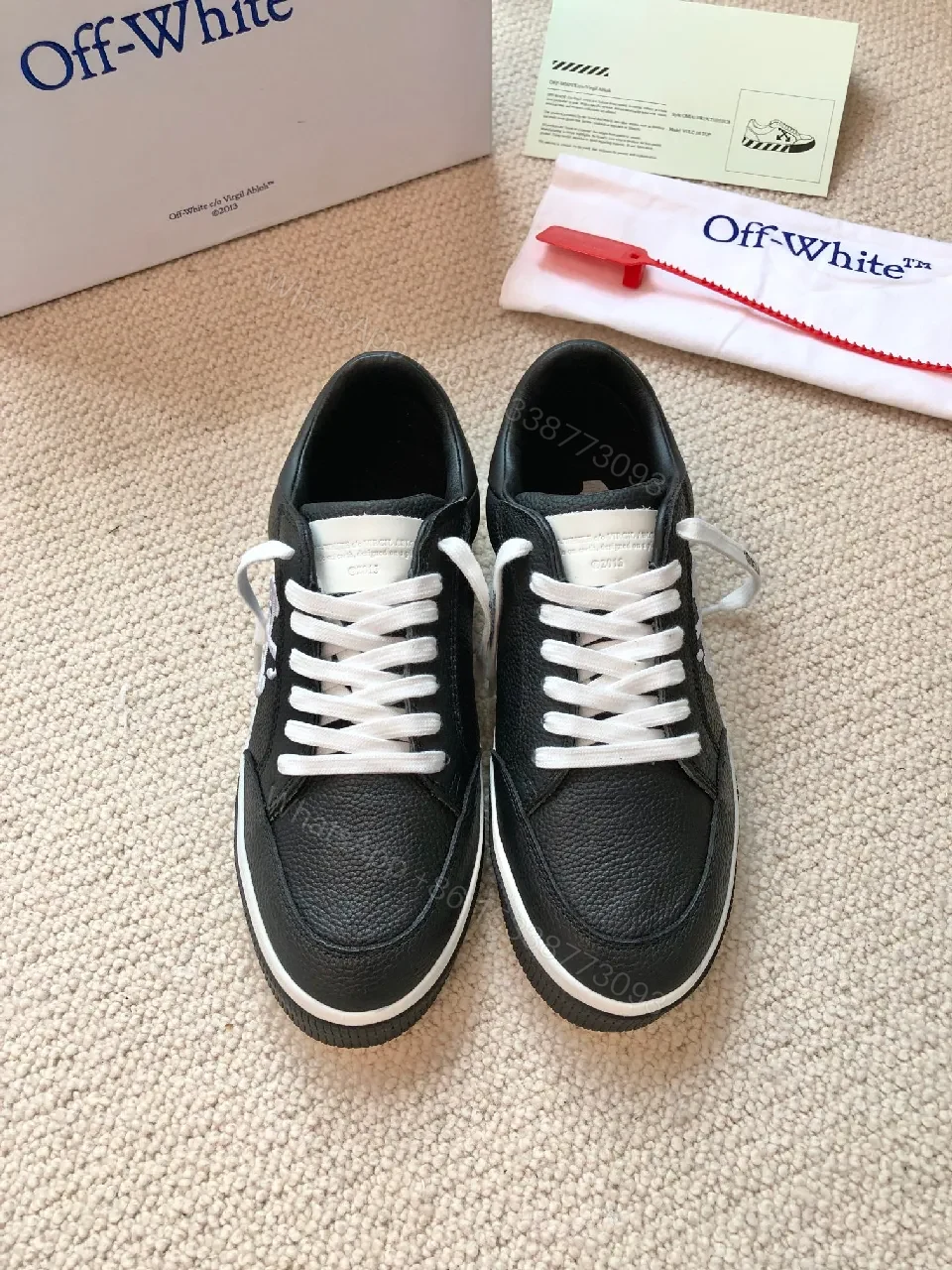 View 2 of Low-Top Black Pebbled Leather Sneakers with Signature Detailing