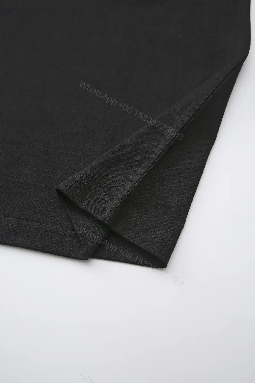 View 2 of Minimalist Black Cotton Tee with Subtle Embossed Logo - T‐Shirt