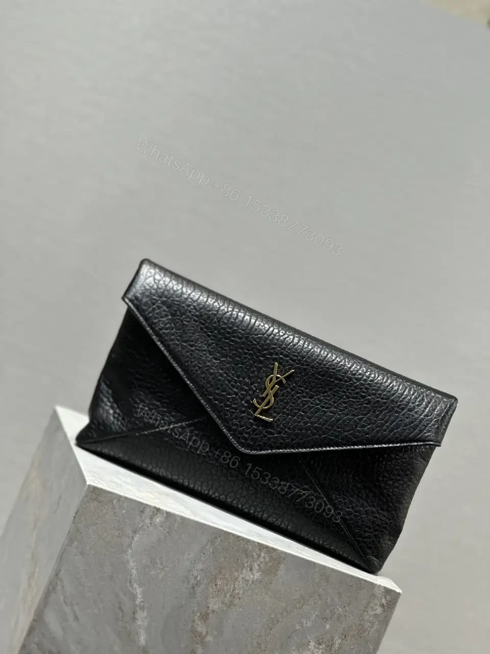 View 2 of Compact Black Leather Envelope Bag with Gold Logo