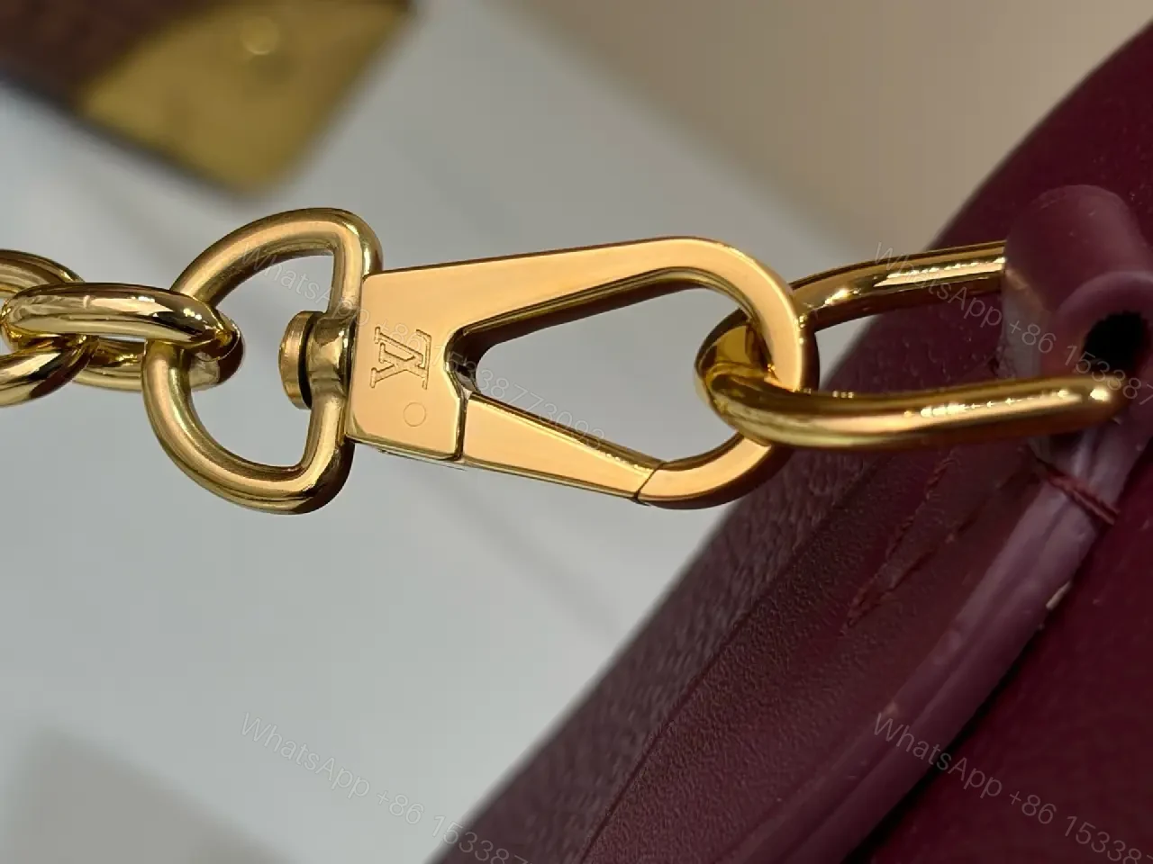 View 3 of Deep Plum Leather Satchel: Structured Top-Handle Bag with Embossed LV Motifs