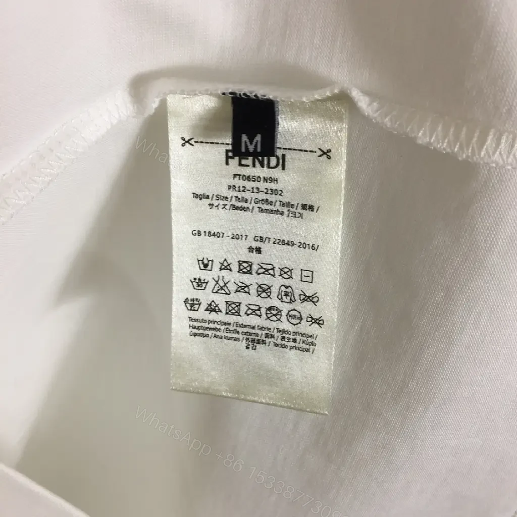 View 7 of White Cotton/Poly blend Short-sleeve Crew Neck Bold FENDI logo with blue flower T-shirt