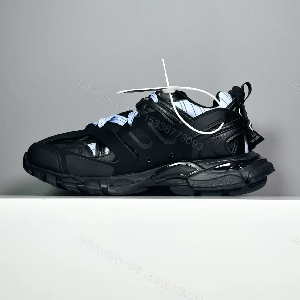 View 3 of black leather and mesh sneakers with logo motif for luxury streetwear