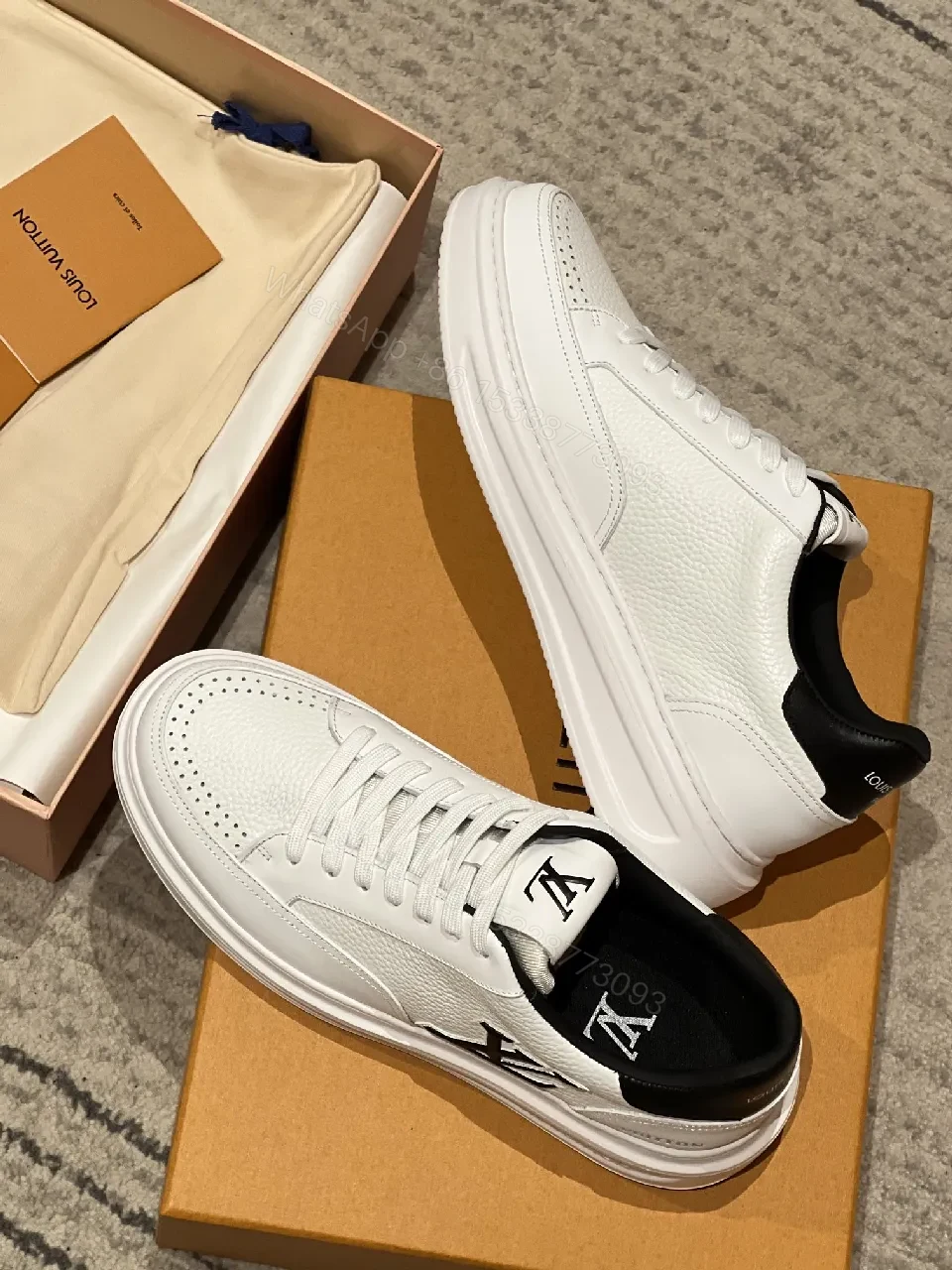 View 4 of Minimalist White Leather Sneakers with Signature Detail - Modern Luxury