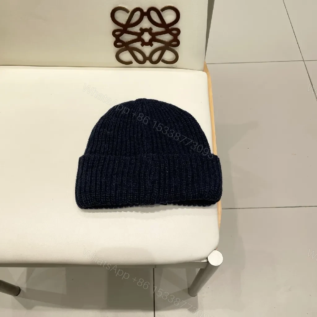 View 5 of Cozy Black Knit Beanie with Subtle Emblem Detail