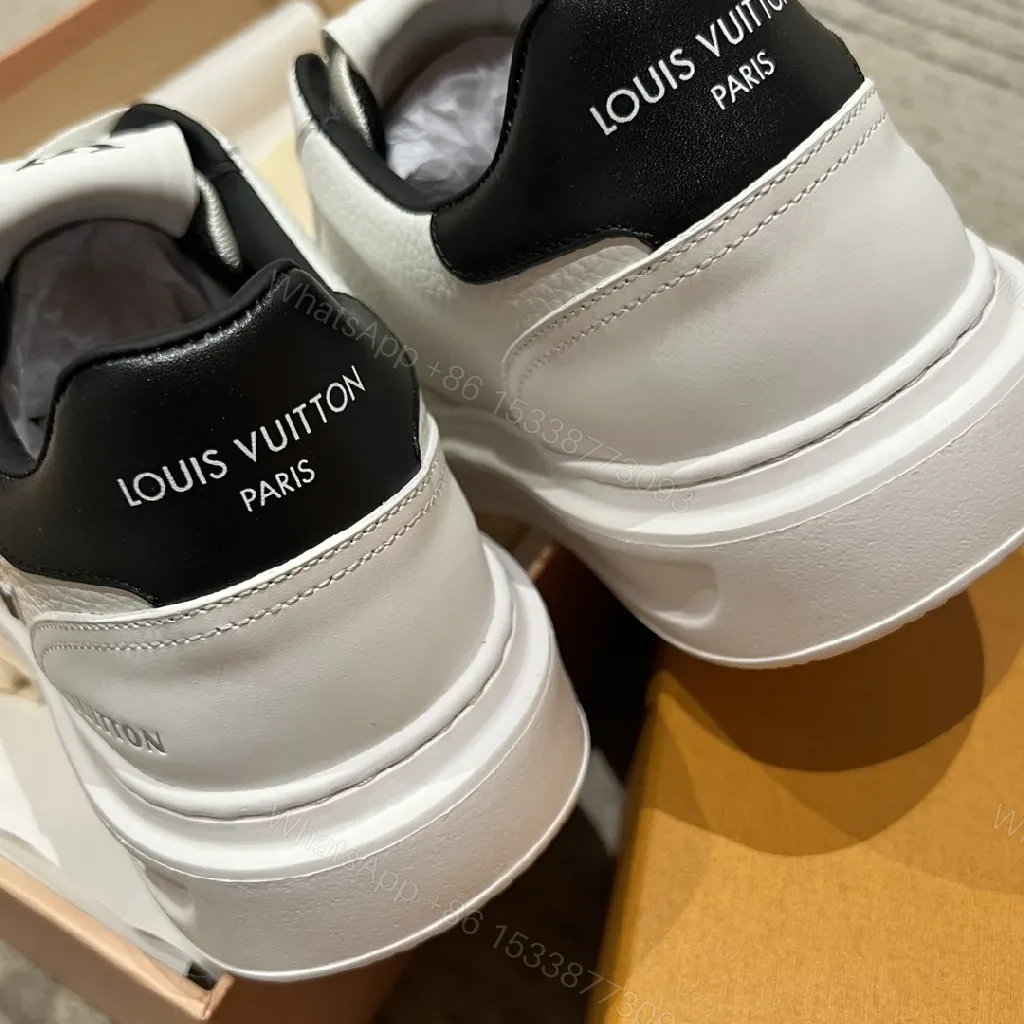 View 7 of Minimalist White Leather Sneakers with Signature Detail - Modern Luxury