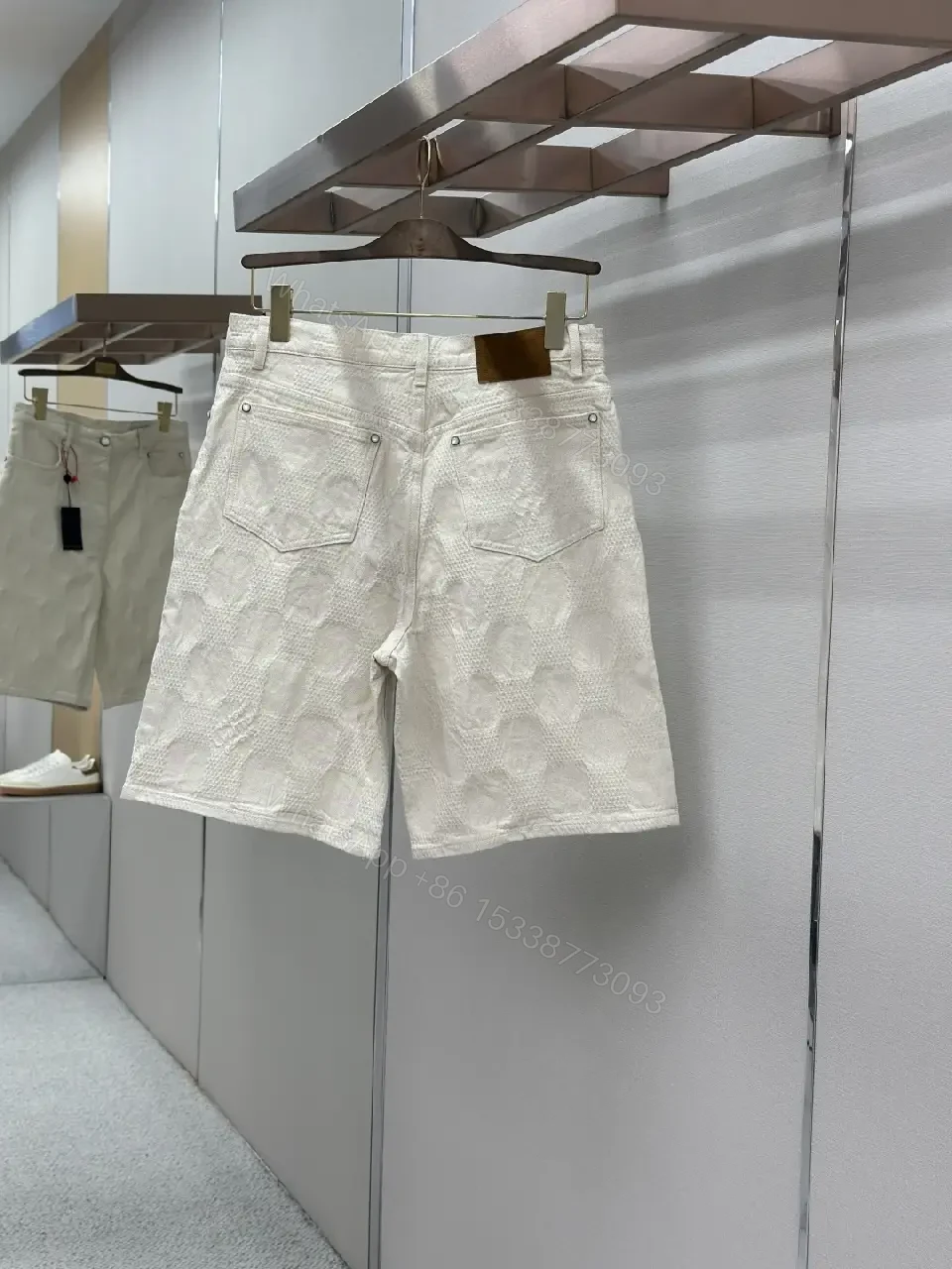View 9 of Beige textured cotton-blend shorts with monogram-inspired print for everyday luxury