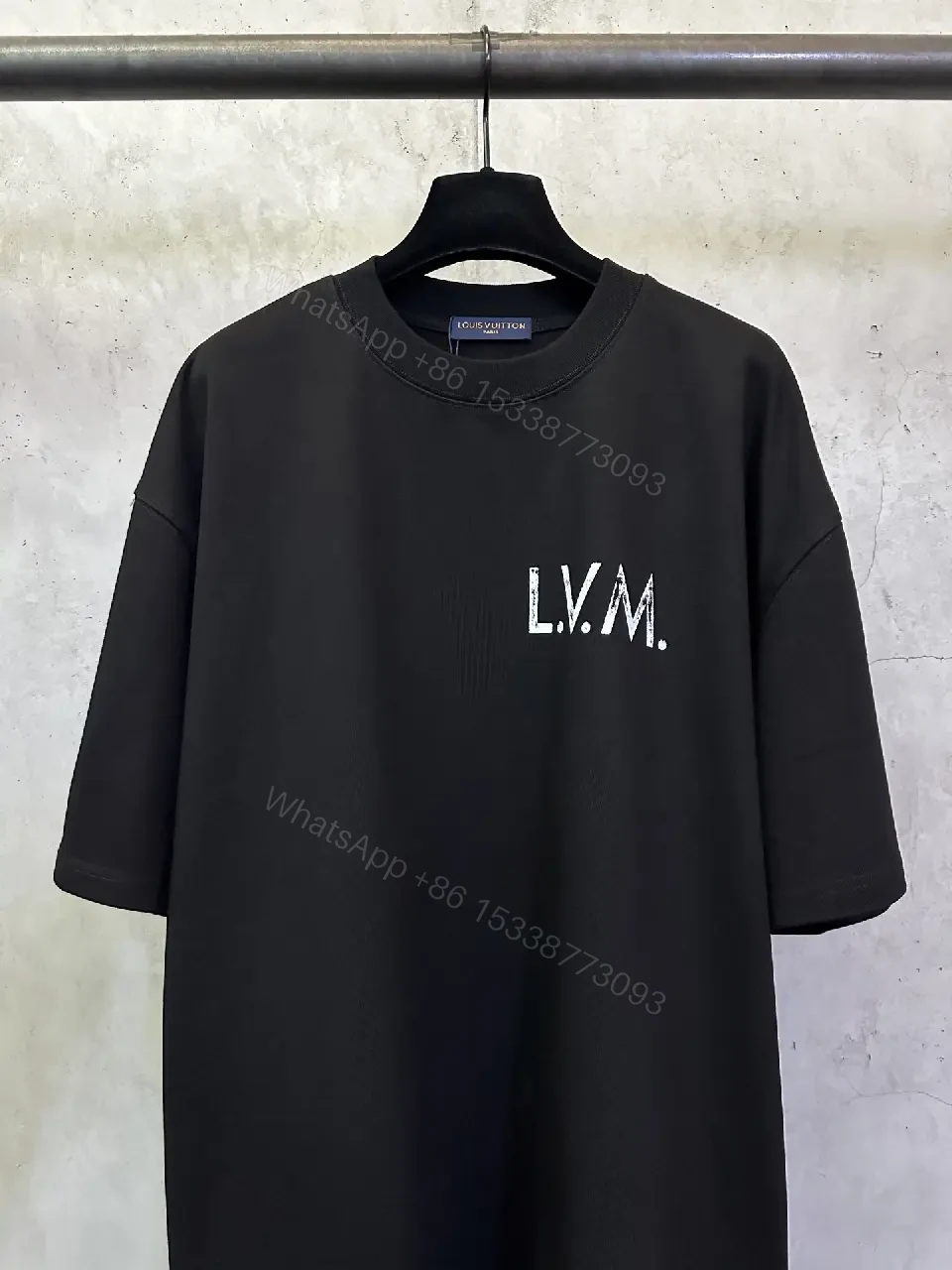 View 9 of Minimalist Black Tee with Subtle LV.M Emblem, Lux Cotton