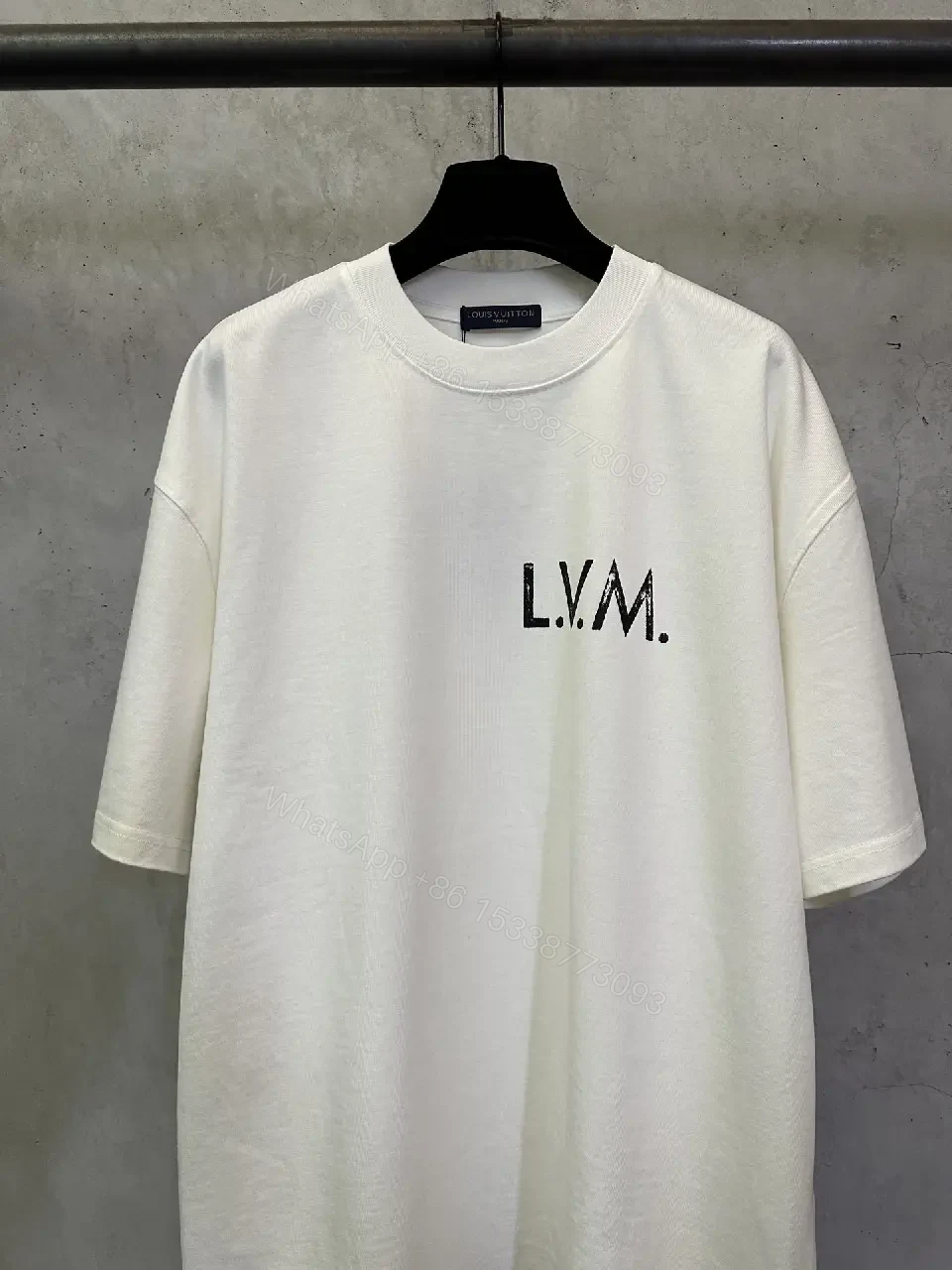View 4 of Minimalist White Tee with Subtle LV.M. Marking — Premium Everyday Wear